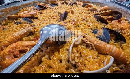 Delicious spanish paella with seafood and spoon ready to be eaten Stock Photo