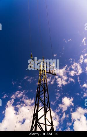 Electric pylon against a vibrant blue sky Stock Photo - Alamy