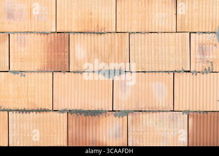 A wall made of hollow bricks. Background Stock Photo