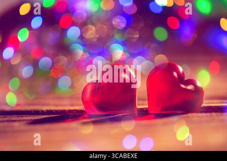 Heart Shape Made of Two Fish Hooks with shadows on wood Stock Photo