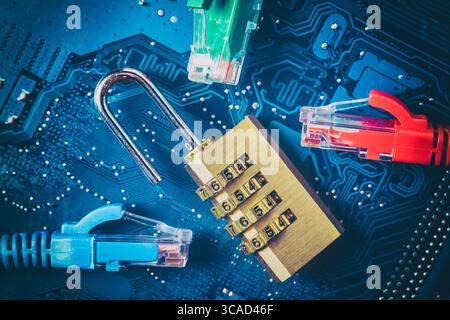 Network ethernet cables near opened padlock on computer motherboard. Internet data privacy information security concept. Blue toned image. Stock Photo