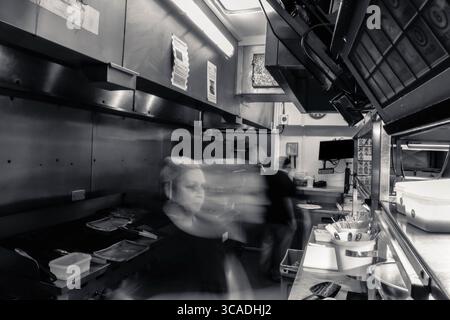 Kitchen action, in a working kitchen. Behind the lines, in the kitchen, long exposure, fast blur, chefs, pub, restaurant, catering, food and beverage Stock Photo