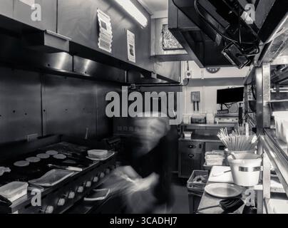Kitchen action, in a working kitchen. Behind the lines, in the kitchen, long exposure, fast blur, chefs, pub, restaurant, catering, food and beverage Stock Photo