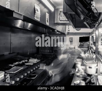 Kitchen action, in a working kitchen. Behind the lines, in the kitchen, long exposure, fast blur, chefs, pub, restaurant, catering, food and beverage Stock Photo