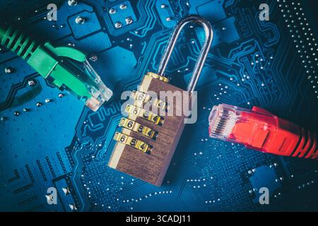 Network ethernet cables near opened padlock on computer motherboard. Internet data privacy information security concept. Blue toned image. Stock Photo