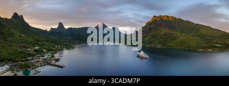 Luxury yacht anchored in Cook's Bay at sunset, Moorea Island, Tahiti. Stock Photo