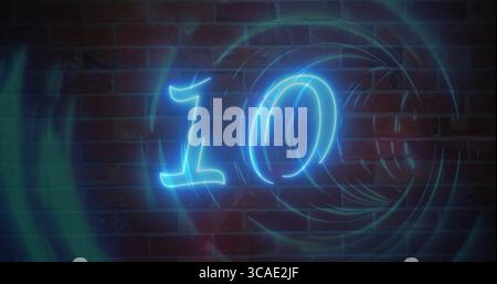 Shining neon blue numeral ten on interior red brick wall, with swirling teal-blue light rings Stock Photo