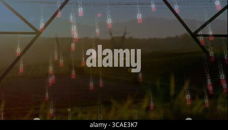 Falling binary code digits streaming over grassy field at dusk, with lattice towers and power lines Stock Photo
