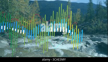 Displaying colored bar chart overlay rising from mountain stream, with red and teal line graphs Stock Photo