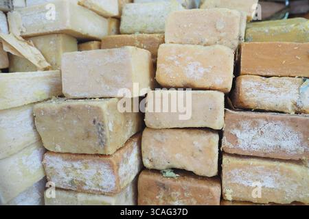 Natural handmade soap bricks stacked for sale in market Stock Photo