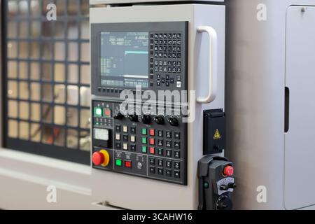 CNC control panel and handheld remote control. CNC machining center close up. . Selective focus. Stock Photo