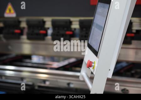 Press brake machine control console close up. Touchscreen control console of hydraulic sheet metal bending machine. Selective focus. Stock Photo