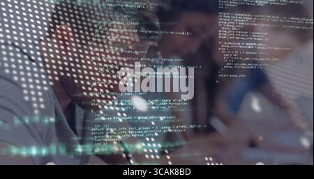 Writing developer taking notes on notebook at desk, showing code overlay, tablet, copy space Stock Photo