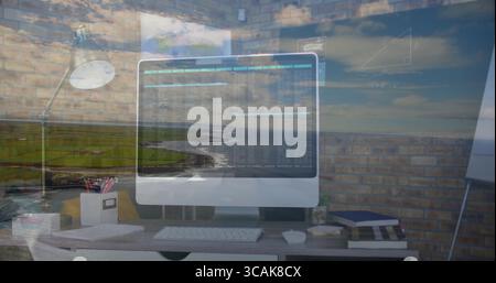 Displaying code on silver-framed widescreen monitor at home office desk, with keyboard and mouse Stock Photo