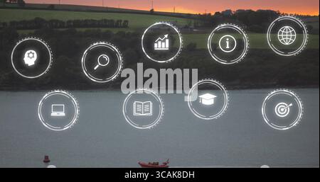 Floating ten white circular digital icons across waterfront at dusk, with red boat and buoy Stock Photo