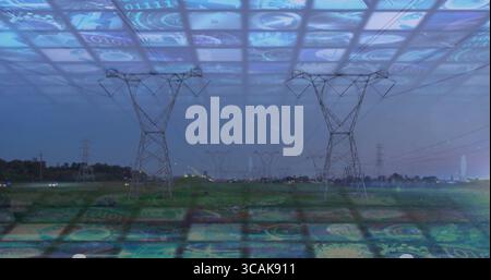 Blending high-voltage towers and power lines rising over grassy field at dusk, with digital panels Stock Photo