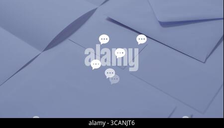 Floating six stylized white chat bubble icons above overlapping envelopes on light-blue tabletop Stock Photo