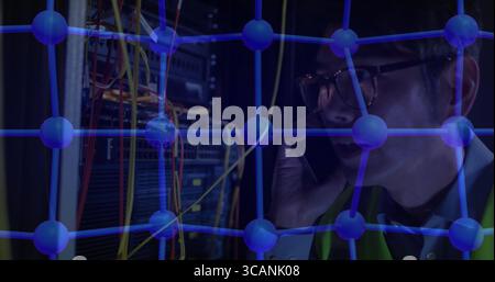 Holding smartphone technician managing digital network nodes in server room with cables, copy space Stock Photo