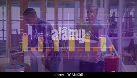 Office workers carrying cardboard boxes in open office, with financial charts, potted plant Stock Photo