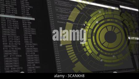 Displaying yellow-green circular HUD graphic rotating on desktop, with code window, copy space Stock Photo