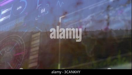 Displaying translucent interface overlaying grassy rural field with power towers, showing gauges Stock Photo