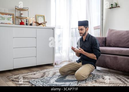 Muslim man praying at home Stock Photo