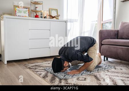 Muslim man praying at home Stock Photo