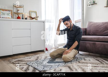 Muslim man praying at home Stock Photo