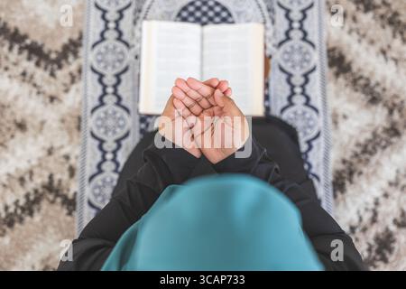 Muslim woman praying at home Stock Photo