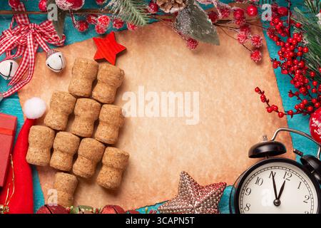 Christmas tree made from wine or champagne corks on old paper, vintage clock and decorations Stock Photo