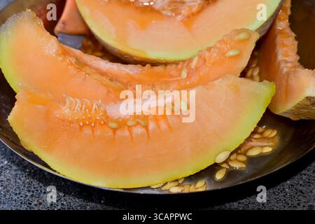 Fresh melons ( Cantaloupe) are the cuts and seed of the fruit in the plate Stock Photo