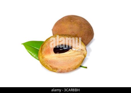 Slice of sapodilla, Chickoo fruit with leaves isolated on white background Stock Photo
