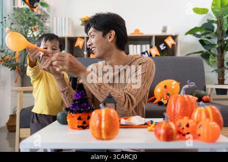Halloween Celebration. Father and son enjoying festive activities together. Stock Photo