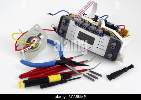 VILNIUS, LITHUANIA - MAY 11, 2016: Repair of spar parts and printed circuit boards from modern household appliances of the Philips brand demands preci Stock Photo