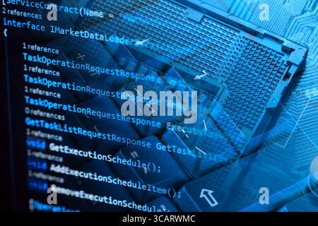 Information technology concept. Coding programmer language script text on screen monitor display with a PC keyboard and processor socket. Programmer o Stock Photo