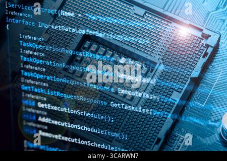 Information technology concept. Coding programmer language script text on screen monitor display with a PC keyboard and processor socket. Programmer o Stock Photo
