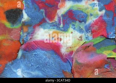 Abstract spots are formed by mixing kids plasticine of different colors. Studio macro background Stock Photo