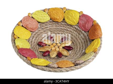 Easter handmade nest made from rope. past and vegetables seeds. Isolated on white macro Stock Photo