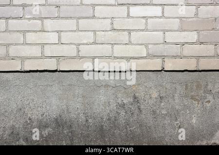 Sharp border between a white silicate bricks and plaster wall texture background Stock Photo