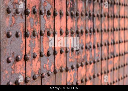 Detailed macro of aged rusty metal plates connected with rivets ideal for industrial background or texture Stock Photo