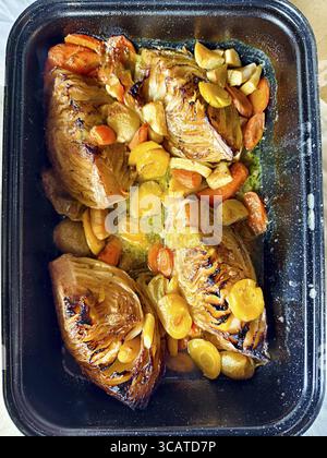 Various root vegetables baked golden brown in a rectangular baking tin Cooked roast cabbage Lower Austria Austria Stock Photo