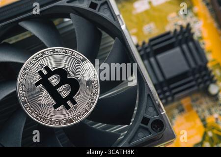 Bitcoin on the CPU processor cooper and yellow computer circuit motherboard close up. Cryptocurrency virtual money background Stock Photo