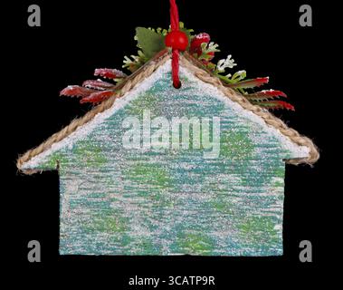 Homemade Christmas tree decoration home made of wood, plaster and glitters. Isolated on black Stock Photo