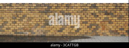 Long fence from yellow burned clay bricks panoramic fragment. Isolated on top Stock Photo