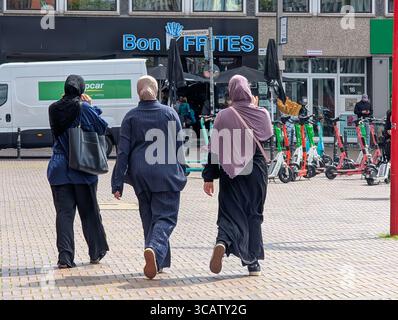 Three women wearing hijabs walk through the city center in Cologne, North Rhine-Westphalia, Germany, August 3, 2025. Stock Photo