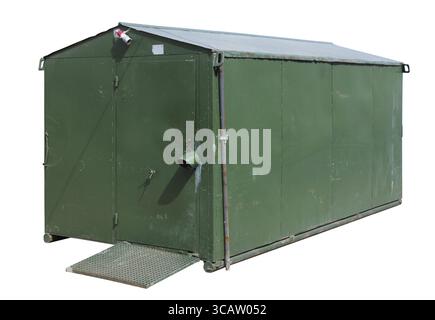 The small closed metal rural shed barn is painted with green paint. All walls in rust spots. Isolated on white Stock Photo
