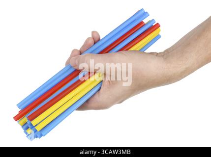 The old man holds in his hand a lot of long plastic multicolored cocktail straws. Isolated on white studio closeup shot Stock Photo