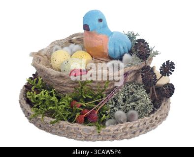 Easter handmade nest from rope and moss with funny blue clay bird and eggs . Isolated on white studio macro shot Stock Photo