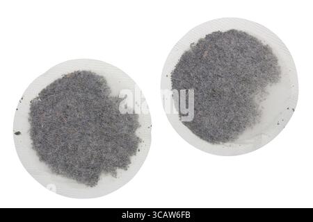 Two round paper bags with dry green tea. Isolated on white studio macro shot Stock Photo
