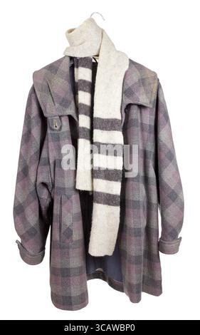 Women's checkered tweed old coat, wool angora scarf hanging on a hanger. Mass production. Isolated with patch Stock Photo